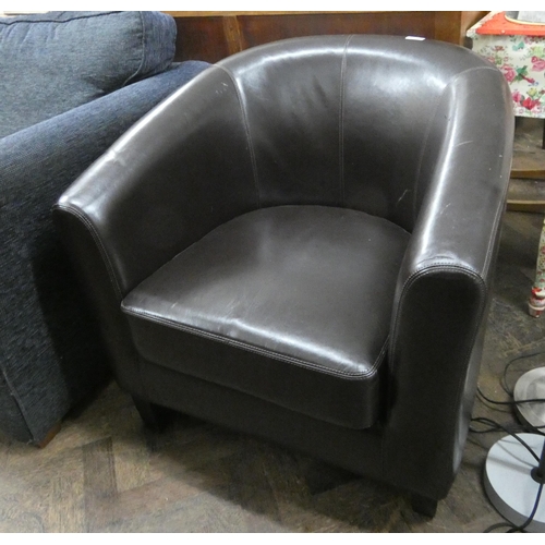 73 - A small tub shaped easy chair in chocolate brown faux leather