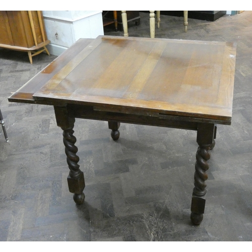 77 - An oak drawer leaf dining table on barley twist legs, 3' square