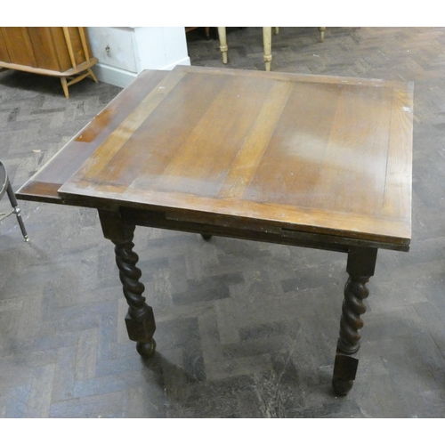 77 - An oak drawer leaf dining table on barley twist legs, 3' square