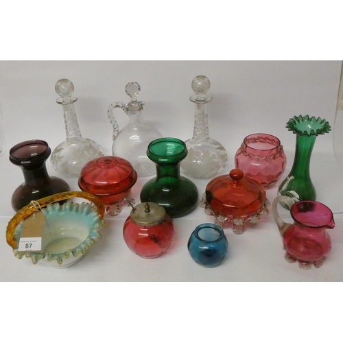 87 - A collection of Victorian glassware to include Cranberry glass, etched glass decanters, Mary Gregory... 