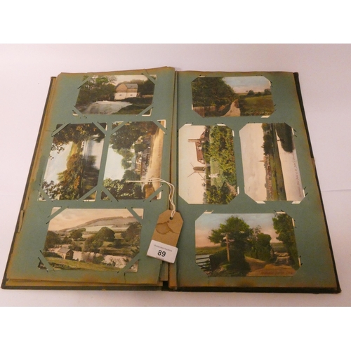 89 - A vintage postcard album and contents