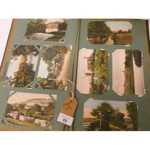 89 - A vintage postcard album and contents