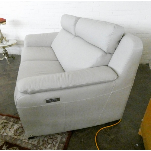 239 - A Nicoletti Italian two seater fully reclining electric settee in pale stone leather, 195cms long  x... 