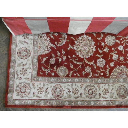 240 - A pair of large red and fawn pattern rugs each 7'6 X 5'6 approximately