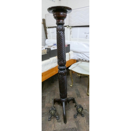 260 - A mahogany twist column torchiere and a pair of iron fire dogs