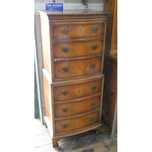 20 - A small Georgian style figured walnut bow front tallboy chest of six drawers with brass handles.