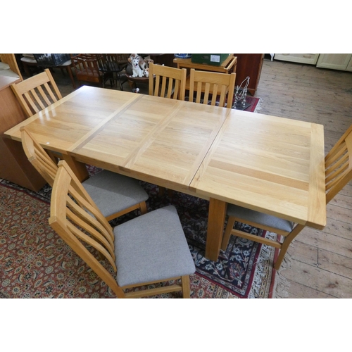 107 - A modern light oak extending dining table with two extra centre leaves and a set of six slat back ma... 