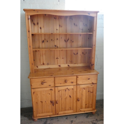 16 - A modern pine kitchen dresser with shelf back, drawers and cupboards under, 46