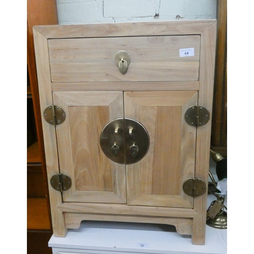 44 - Stripped and waxed pine Chinese style bedside cabinet with brass furniture fittings