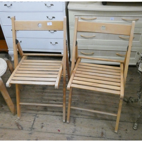 53 - A set of four fold-up kitchen chairs