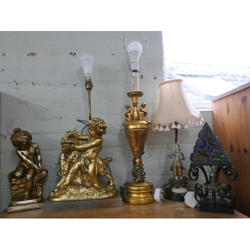 66 - Two gilt figure decorated table lamps, another figure table lamp, iron and glass lamp and a cherub o... 