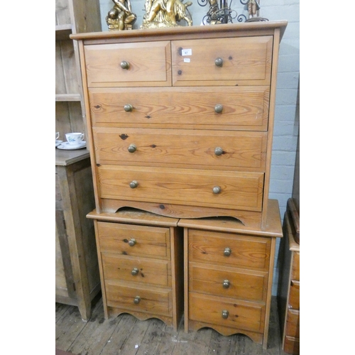 67 - A modern pine chest of three long and two short drawers and a pair of matching three drawer bedside ... 