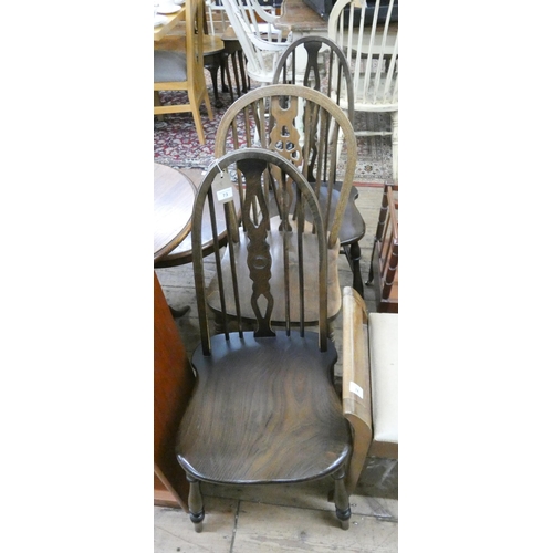 73 - A pair of Windsor hoop back dining chairs and one wheel back chair