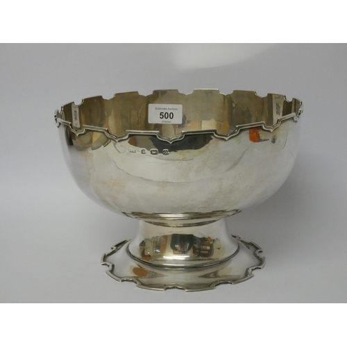 500 - A large Mappin & Webb silver Monteith bowl with a crenelated edge and pedestal foot, Birmingham hall... 