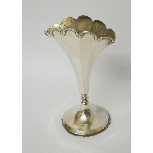 502 - A fan shaped silver trumpet vase on circular weighted base. Approximately 18cms tall