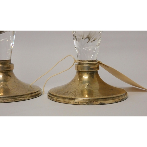 503 - A pair of cut glass specimen vases with hallmarked silver bases, 21cms tall