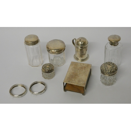 507 - A silver pepperette and a collection of silver topped dressing table jars, silver matchbox holder an... 