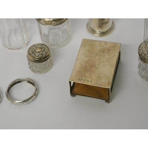 507 - A silver pepperette and a collection of silver topped dressing table jars, silver matchbox holder an... 