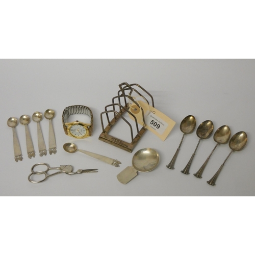 509 - A hallmarked silver toast rack, various small silver spoons, caddy spoon and a vintage wristwatch, w... 