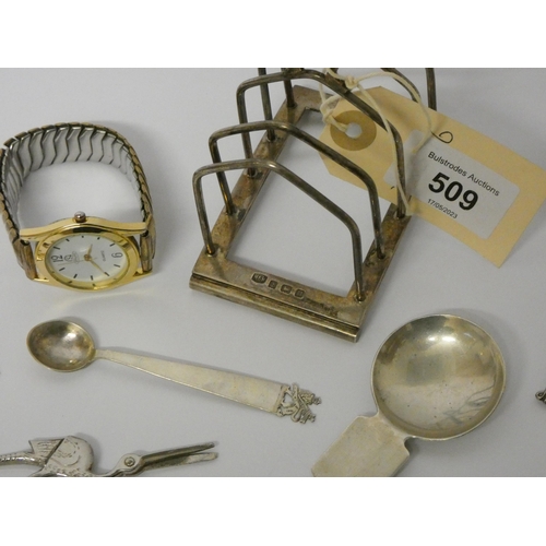 509 - A hallmarked silver toast rack, various small silver spoons, caddy spoon and a vintage wristwatch, w... 