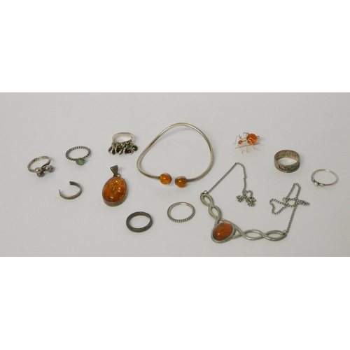 569 - Silver and amber jewellery to include a bangle, dress rings etc