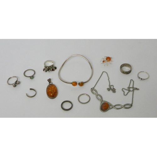 569 - Silver and amber jewellery to include a bangle, dress rings etc