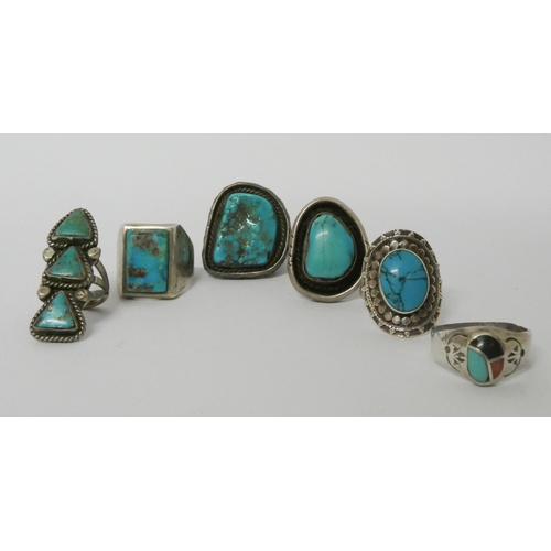 570 - A collection of six large statement silver and turquoise set dress rings