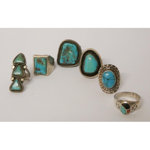 570 - A collection of six large statement silver and turquoise set dress rings