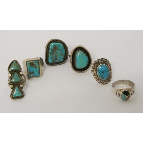 570 - A collection of six large statement silver and turquoise set dress rings