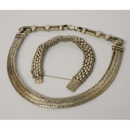 576 - A silver gate style bracelet and a heavy Indian white metal choker necklace