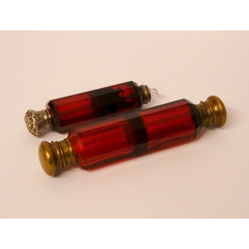 512 - Two Victorian ruby glass double ended scent bottles, the largest measures 13cms long