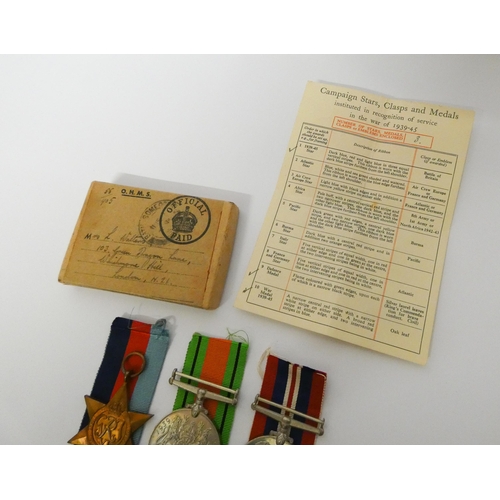 198 - Three medals of the Second World War in original box with ribbons and condolence slip, named Tempora... 