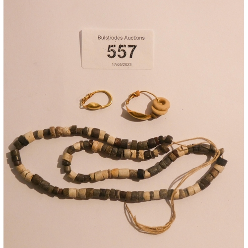 557 - Three pieces of ancient jewellery to include a Hittite bead necklace dating from a 1000 BC together ... 