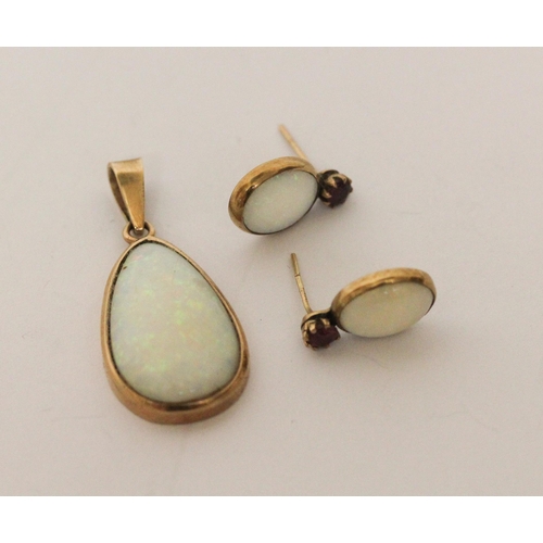 585 - Large oval opal pendant 20mm across together with a pair of  opal and ruby stud fitting earrings