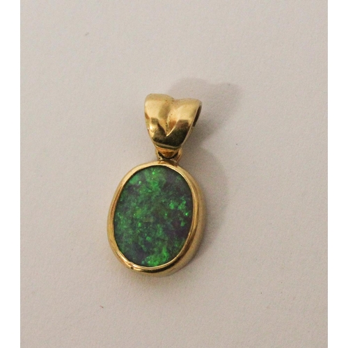 588 - 18ct yellow gold oval opal pendant, size 16mm including suspension loop