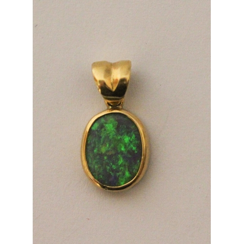 588 - 18ct yellow gold oval opal pendant, size 16mm including suspension loop