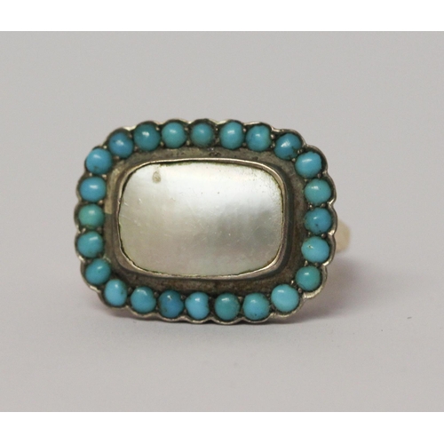 620 - An antique turquoise and mother of pearl panel ring, the closed back rectangular setting to a simple... 