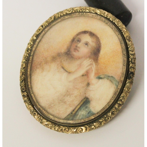 653 - A large oval brooch, set with devotional image miniature within glazed frame with closed back. Unmar... 