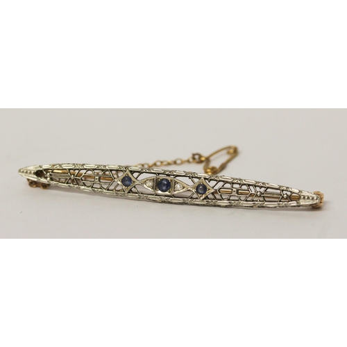 655 - An Art Deco style sapphire and diamond brooch, in openwork lozenge panel, marked 14k on pin fastener... 