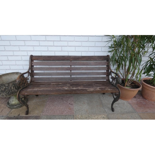 741 - A metal ended wooden seat garden bench with lion mask finial