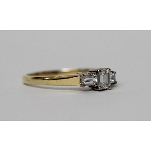 629 - Modern diamond three stone ring, set with princess cut and baguette diamonds, on hallmarked 18ct yel... 