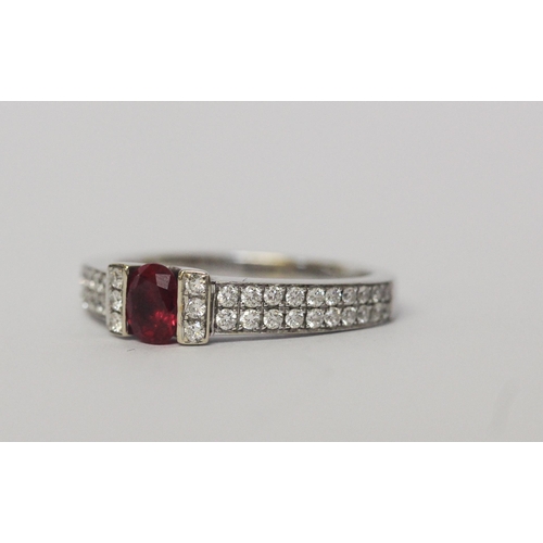 642 - A ruby and diamond band, in a modern setting with pave diamond shoulders, 18ct white gold, hallmarke... 