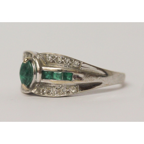 643 - An emerald and diamond modern band ring, on 18ct white gold shank, marked 750.  Ring size R