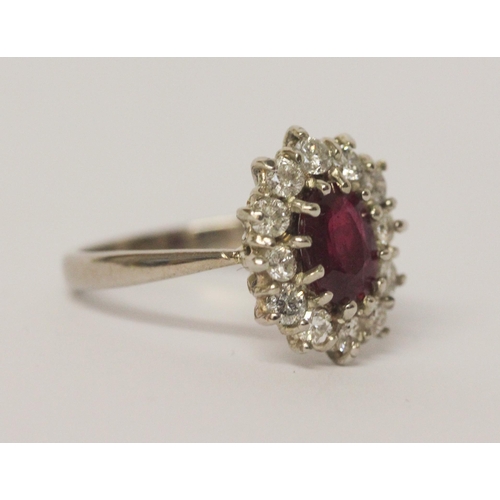 658 - A large ruby and diamond oval cluster ring, the ruby weighing approximately 1.5 carats and diamonds ... 