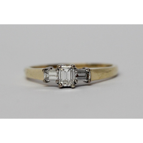 629 - Modern diamond three stone ring, set with princess cut and baguette diamonds, on hallmarked 18ct yel... 