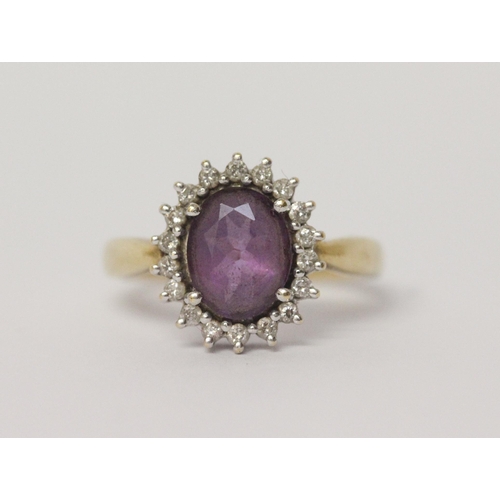 641 - An amethyst and diamond oval cluster ring, on 18ct yellow gold band, hallmarked, ring size N