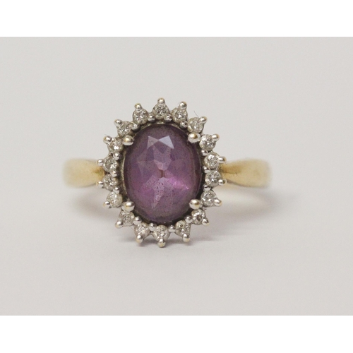 641 - An amethyst and diamond oval cluster ring, on 18ct yellow gold band, hallmarked, ring size N