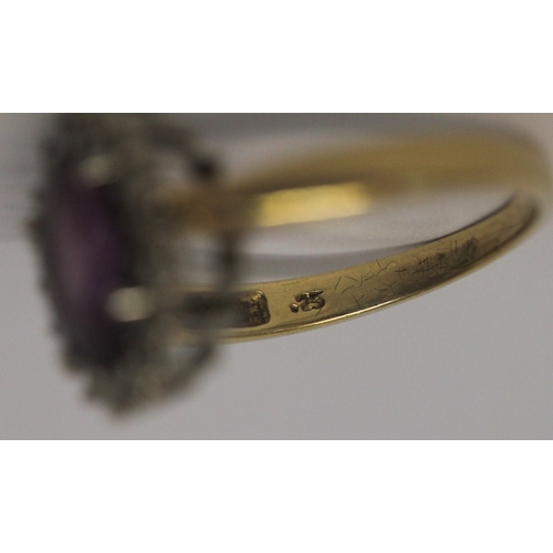 641 - An amethyst and diamond oval cluster ring, on 18ct yellow gold band, hallmarked, ring size N