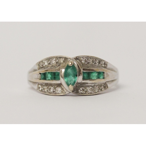 643 - An emerald and diamond modern band ring, on 18ct white gold shank, marked 750.  Ring size R