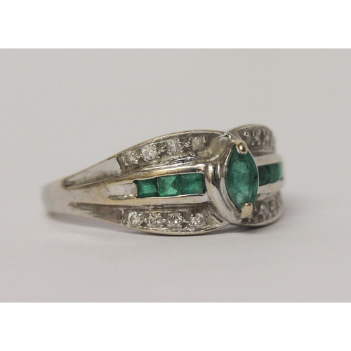 643 - An emerald and diamond modern band ring, on 18ct white gold shank, marked 750.  Ring size R